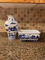 Full view of vase and plant pot side by side on countertop showing overall shape and design.