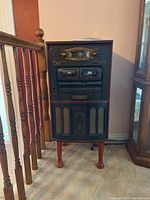 Front view of TEAC GF-680 stereo system showing cassette decks, control knobs, CD player and speaker grills on wooden cabinet.