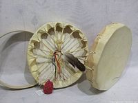 Two native drums and wooden bentwood ring shown together and from the back with visible lacing and rawhide drumhead.