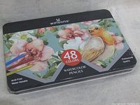 Sealed metal tin box with floral and bird artwork showing Winsons brand and 48 colors.