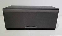 Front view of Sony SS-CN550H center speaker showing black fabric grille and cabinet with slight surface wear on top.