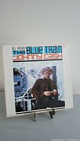 Front cover of the vinyl record featuring Johnny Cash standing by a train.