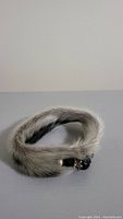 Side view of fur bracelet showing pattern, texture and clasp closure.