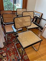 Five cantilever armchairs arranged in a room
