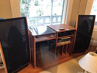 Two Dahlquist DQ-20 speakers flanking a stereo rack