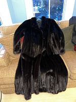 Front view of the full-length coat laid flat