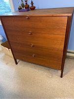 Front view of four-drawer walnut veneer dresser