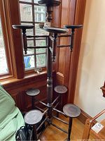 Side view of wooden multi-platform plant stand with six round platforms at different heights