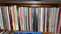 Shelf filled with vintage vinyl albums mostly classical and world music. Various titles and artists visible on spine.