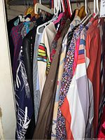 Overview of rack showing multiple women's garments on hangers