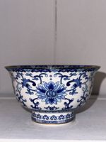 Front view of hand painted Chinese blue and white footed bowl showing floral patterns and foot ring detail.