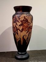 Front side view showing brown and beige cameo glass with flower and vine patterns.