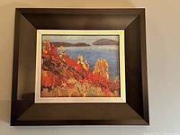 Photo of entire framed artwork showing the full frame and painting.