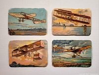 Photo of four vintage airplane postcards showing different early aircraft flying over various scenic backdrops such as water and fields.