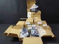 Full view of all 16 HIPRO adapters stacked in original boxes and some adapters shown with packaging open.