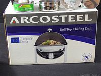 Box showing the Arcosteel branding and image of the roll top chafing dish