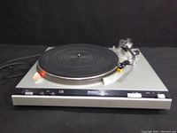 Front view of turntable showing platter, tonearm and control panel