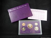 Photo of 1992 United States Mint Proof Coin Set including 5 proof coins in original clear plastic holder, purple card insert, purple outer sleeve and informational insert.
