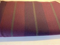 Clear photo showing the wool fabric's striped pattern with burgundy, purple, and thin green lines.