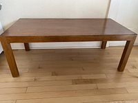 Full front view of the rectangular coffee table showing legs and top