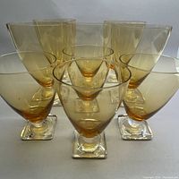 Front view showing all 9 glasses arranged with taller glasses in the back and shorter in front