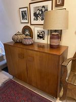 Full front view showing cabinet closed with decorative items on top