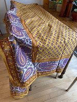 Tablecloth draped over table showing overall shape and border