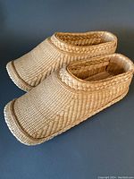 Full view of grass shoes from an angle showing shape and weave pattern