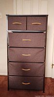 Front view of the 6-drawer dresser showing brown fabric drawers with wooden handles in metal frame.