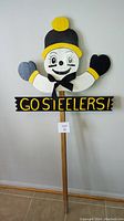 Full view of the Go Steelers wooden staked party sign showing the entire height including the stake, character, and text panel.