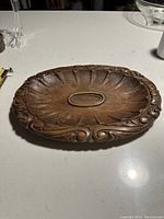 Top view showing the full wooden platter with carved ornamental designs