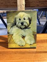 Front view of 11x14 dog print on wooden surface with metal structure background