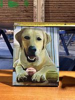 Front view of the framed dog print with measuring tape showing width approximately 14 inches.