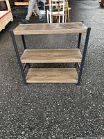 Full view of the three-tier shelving unit showing metal frame and wooden shelves