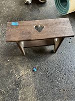 Top-down view of the wooden stool showing heart-shaped cutout on the seat.
