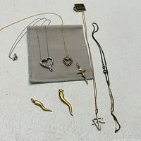 Photo showing all 7 jewelry pieces including pendants and necklaces with mixed gold and silver tones