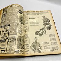 Open page showing newspaper advertisements and articles within the volume.