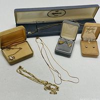 Front view of all jewelry items arranged on white surface