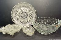 Five vintage clear crystal or glass serving pieces displayed, showing size and detailing.