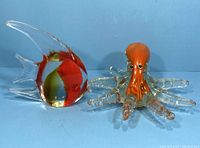 Octopus and angelfish marine glass figurines side by side, showing color and size comparison