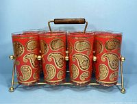 Front view of eight glasses in metal caddy