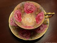 Top-down view of teacup positioned on saucer showing interior and saucer rose pattern