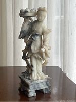 Full view of the statue showing the base, overall figure and fruit tray attached on the side.