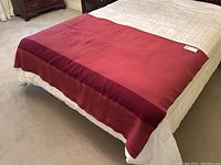 Vintage Hudson's Bay wool point blanket laid on a bed showing full length and border detail.