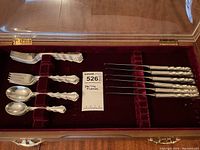 Full view of all flatware pieces displayed in velvet-lined case