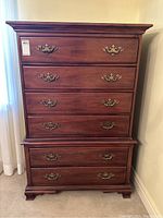 Frontal view of dresser showing four drawers in top section and two in bottom section