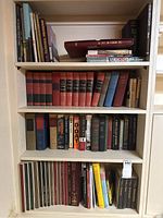 Four-shelf bookcase containing assorted books