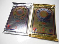 Two unopened wax packs of 1992 Leaf Set Baseball cards, one silver (Series 1) and one gold (Series 2).