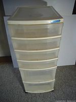 Front view of the 34-inch tall five drawer plastic storage unit showing translucent drawers and white plastic frame with stains.