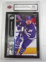 Front of the Auston Matthews 2021-22 Upper Deck hockey card showing player image, name, and grading label.